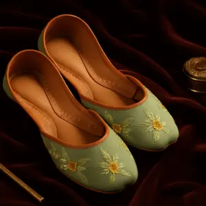 Traditional green khussa shoes with yellow floral embroidery on velvet background, handcrafted ethnic footwear for women.