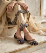 Bridal khussa for women worn with an ankle anklet and beige embroidered outfit, elegant bridal footwear