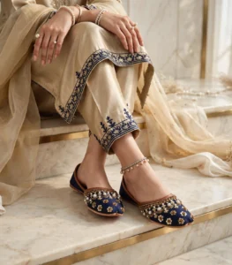 Bridal khussa for women worn with an ankle anklet and beige embroidered outfit, elegant bridal footwear
