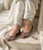 Bridal khussa shoes Pakistan on marble stairs with silver anklet and cream outfit
