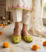 Lime green bridal khussa worn with ivory embroidered shalwar kameez at mehndi function