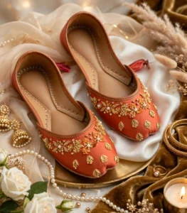 Luxury rust bridal khussa styled with gold jewelry