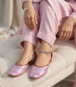 Close-up of pink bridal khussa with pearl bangles