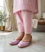 Woman standing in pink khussa with pink shalwar kameez