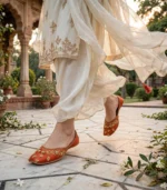 Rust bridal khussa worn outdoors at wedding venue