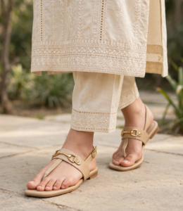 Beige slingback flat sandals paired with a cream chikankari kurta and trousers