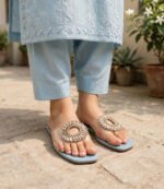 Woman wearing blue party wear flat sandals with embroidered light blue shalwar kameez