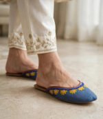 Blue mule khussa paired with ivory trousers featuring gold hand embroidery