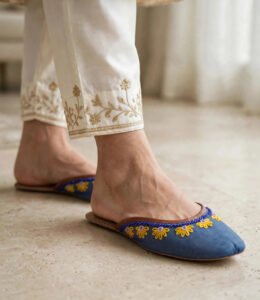 Blue mule khussa paired with ivory trousers featuring gold hand embroidery