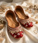 Bridal khussa for women pair with pearl and kundan embellishment, flat lay with jewelry