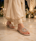 Cream crystal flat slides with transparent strap worn at an evening wedding event
