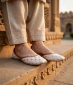 Embroidered khussa shoes for women styled outdoors at heritage site