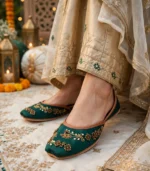 Emerald green bridal khussa worn at a wedding mehndi function with décor