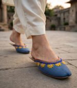 Comfortable flat khussa mules with yellow floral embroidery worn while walking outdoors