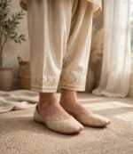 Comfortable flat khussa shoes in cream and gold worn with embroidered cream trousers