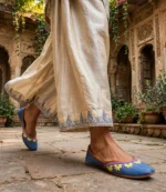 Handmade denim jutti worn with cream palazzo pants in a traditional courtyard