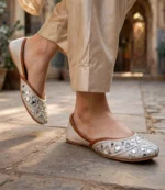 Handmade khussa with mirror and bead work worn with beige silk trousers