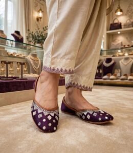 Handmade purple leather khussa worn with cream embroidered trousers