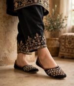 Mirror work khussa shoes captured in outdoor walking shot