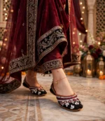 Mirror work khussa women paired with maroon bridal lehenga and gold anklets