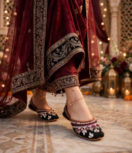 Mirror work khussa women paired with maroon bridal lehenga and gold anklets