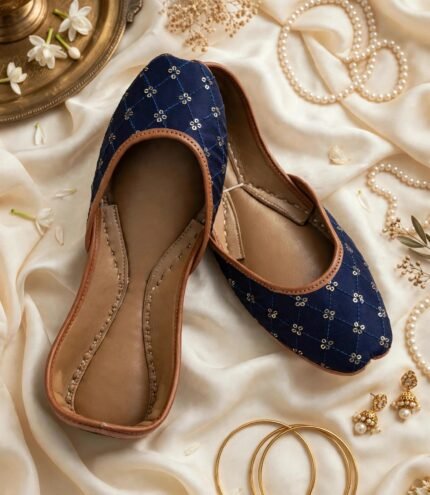Flat lay of navy blue khussa online Pakistan showing leather sole and sequins