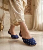 Navy blue khussa online Pakistan paired with golden festive outfit indoors