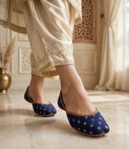 Navy blue khussa online Pakistan paired with golden festive outfit indoors