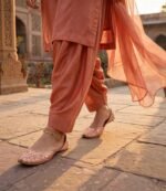 Woman wearing peach khussa flats women with gold anklet