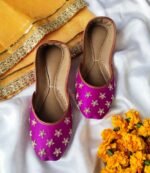Flat lay of pearl work bridal khussa pair showing floral embroidery and tan leather trim