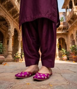 Woman standing in traditional haveli wearing pearl work bridal khussa