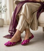 Pearl work bridal khussa worn with cream shalwar kameez, sitting pose