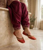 Ladies pearl work khussa in terracotta red paired with a maroon embroidered shalwar
