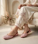 Woman wearing pink bridal khussa online with embroidered ivory kurta