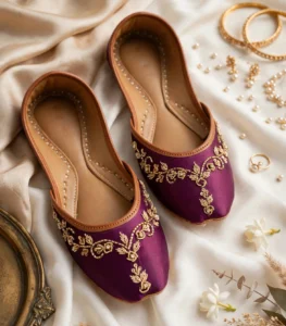 Purple bridal khussa online flatlay styled with gold jewelry and pearls