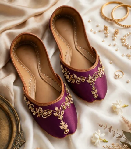 Purple bridal khussa online flatlay styled with gold jewelry and pearls