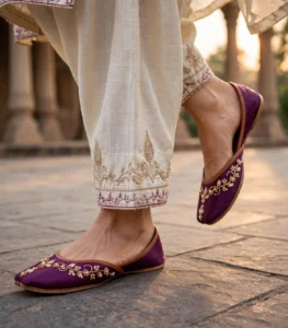 Woman walking in purple bridal khussa online at a heritage location