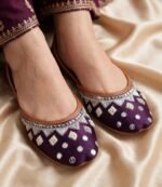 Close-up of silver zari, pearl beads and sequin work on a purple khussa for women