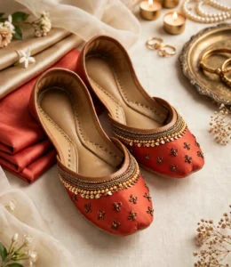 Pair of handcrafted rust red khussa with pearl, sequin and floral beadwork on the toe