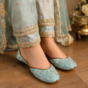 Woman wearing sky blue embroidered khussa in traditional Pakistani outfit