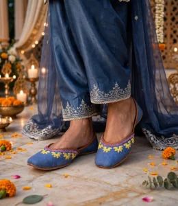 Woman wearing thin sole denim khussa with navy embroidered shalwar and dupatta