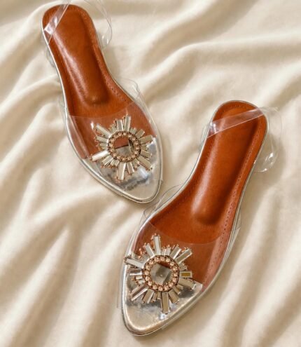 Pair of transparent crystal sandals with sunburst embellishment and tan cushioned insole for women