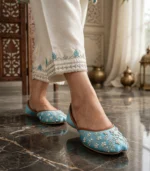 Woman walking in turquoise embroidered khussa for women
