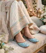 Turquoise embroidered khussa paired with ivory bridal dress