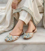 Women khussa flats with tan leather piping worn outdoors in traditional heritage setting