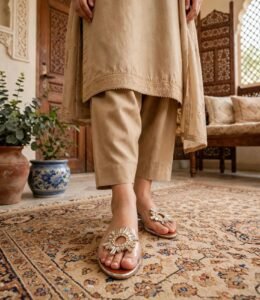 Woman wearing transparent crystal flat sandals with beige embroidered shalwar kameez