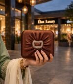 Ladies copper box clutch with rhinestone buckle carried with festive formal wear