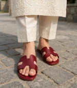 Maroon ladies flat chappal worn with cream chikankari embroidered suit