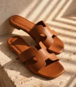 Close-up of ladies leather flat sandals in tan with soft cushioned footbed
