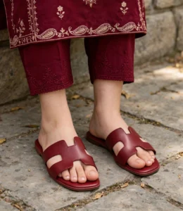 Maroon flat sandals styled with embroidered maroon shalwar kameez